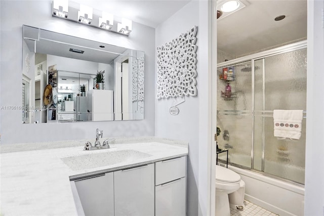 full bathroom with tile patterned flooring, vanity, toilet, and enclosed tub / shower combo