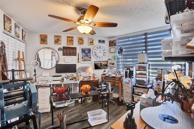 office area featuring dark hardwood / wood-style floors, ceiling fan, and a textured ceiling