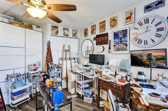 home office with a textured ceiling, ceiling fan, and dark wood-type flooring