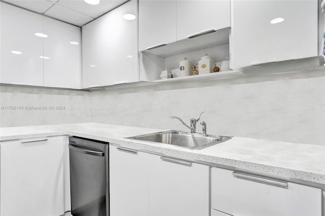 kitchen featuring sink, white cabinets, and a drop ceiling