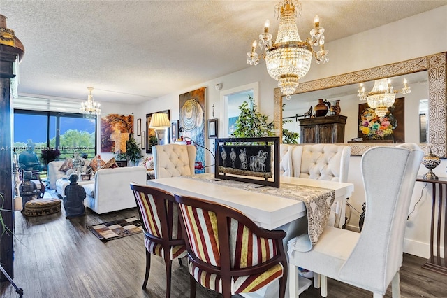 dining area featuring a notable chandelier, dark hardwood / wood-style flooring, and a textured ceiling