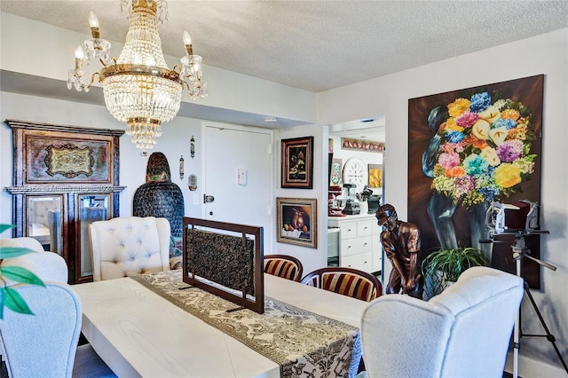 dining area featuring a textured ceiling and an inviting chandelier