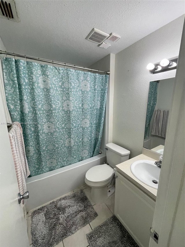 full bathroom with vanity, shower / bath combo, tile patterned floors, toilet, and a textured ceiling