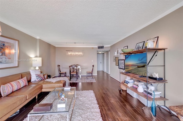 living room featuring a textured ceiling, dark hardwood / wood-style floors, and ornamental molding