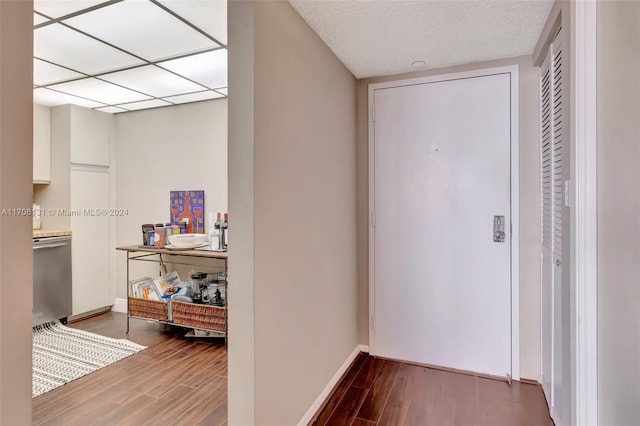 hallway featuring wood-type flooring and a textured ceiling