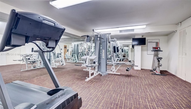 exercise room with dark colored carpet