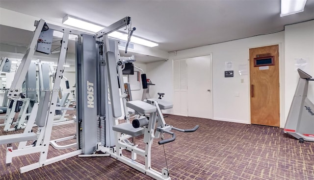 exercise room featuring dark colored carpet