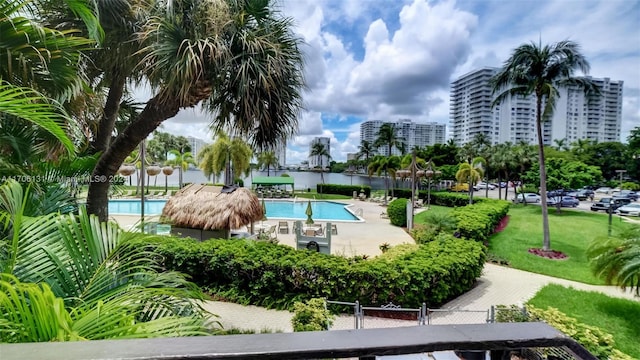 view of pool with a patio area and a lawn