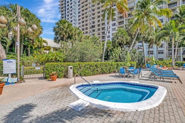 view of swimming pool with a patio and a hot tub