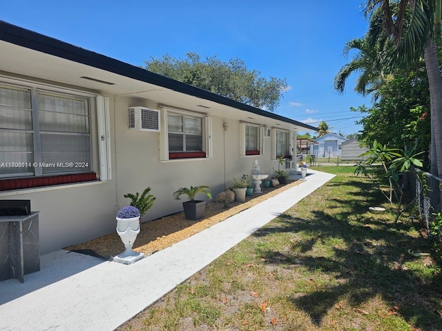 view of side of property with a lawn