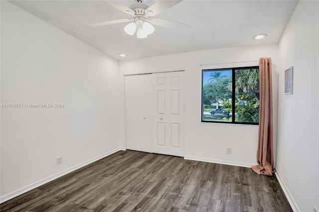 unfurnished bedroom featuring ceiling fan, a closet, and wood-type flooring