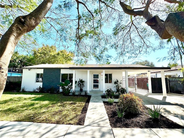 view of front facade with a front yard and a carport