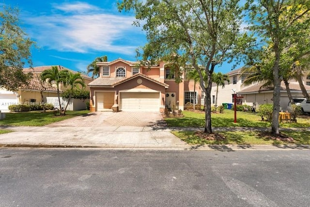 mediterranean / spanish house with a front lawn and a garage