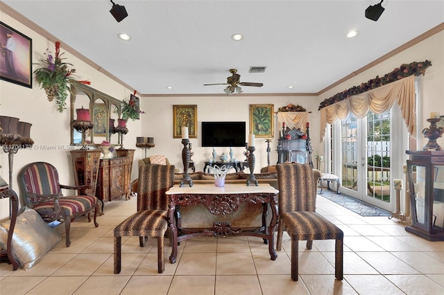 tiled dining room featuring ceiling fan and crown molding