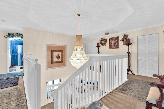 corridor featuring carpet flooring, a raised ceiling, and ornamental molding