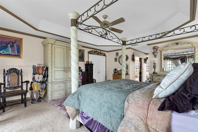 carpeted bedroom featuring a raised ceiling, ceiling fan, and ornamental molding