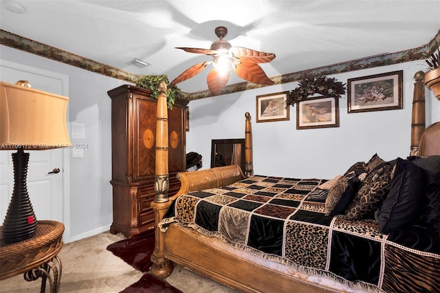 bedroom with carpet, ceiling fan, and a textured ceiling