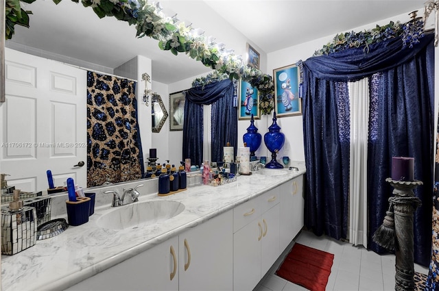 bathroom with tile patterned floors and vanity