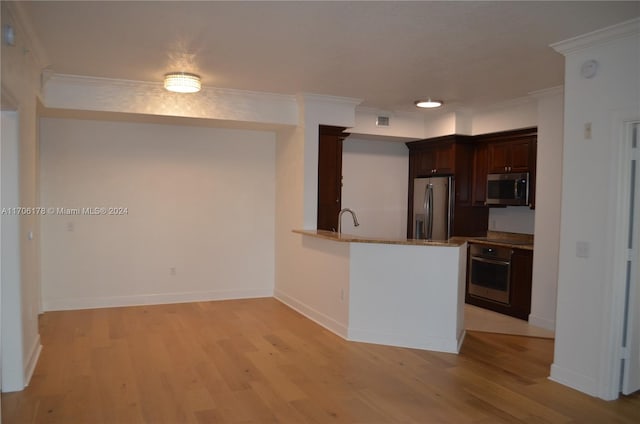 kitchen with kitchen peninsula, crown molding, light hardwood / wood-style floors, and appliances with stainless steel finishes