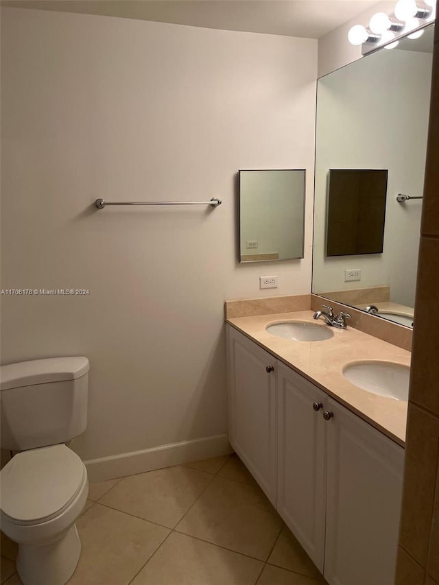 bathroom featuring toilet, vanity, and tile patterned floors