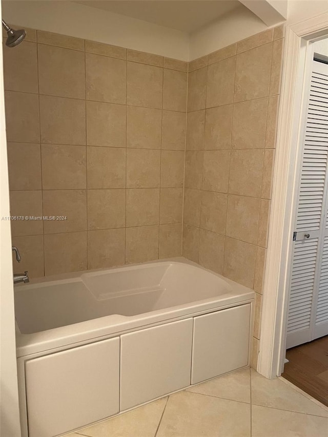 bathroom featuring tile patterned flooring and tiled shower / bath combo