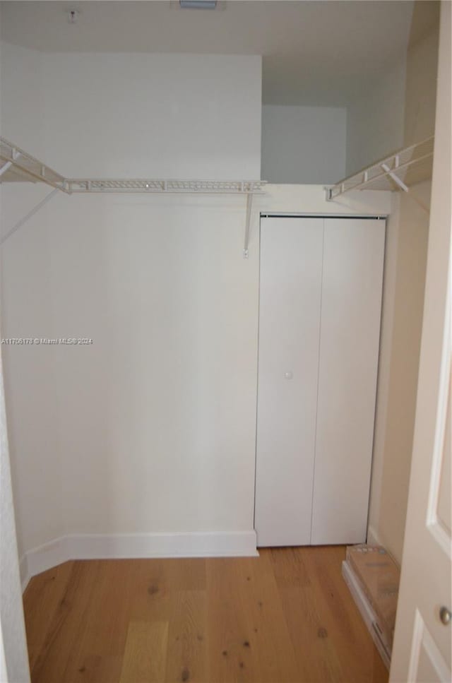 walk in closet featuring light hardwood / wood-style floors