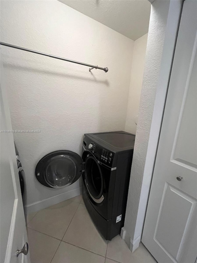 washroom featuring washer / clothes dryer and tile patterned floors