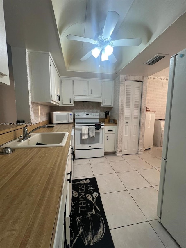 kitchen with ceiling fan, a sink, white appliances, white cabinetry, and visible vents