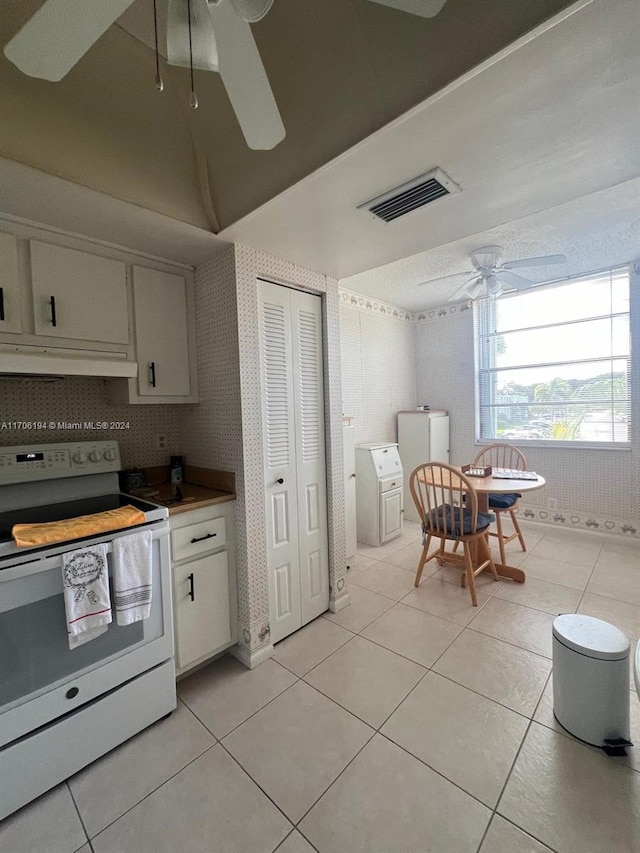 kitchen with tasteful backsplash, ceiling fan, light tile patterned floors, white range with electric cooktop, and white cabinetry