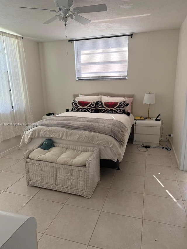 bedroom featuring ceiling fan and light tile patterned flooring