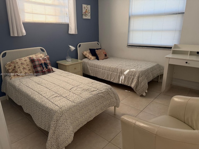 bedroom featuring multiple windows and light tile patterned flooring