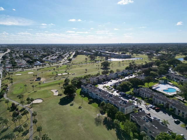 drone / aerial view featuring view of golf course and a water view