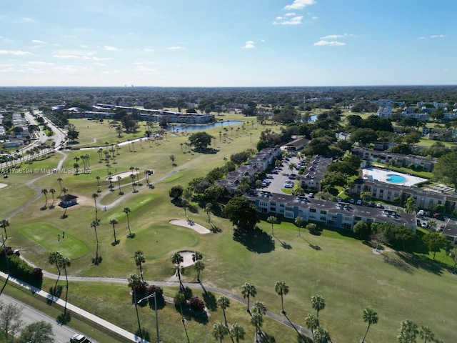 drone / aerial view with a water view and golf course view