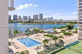 view of swimming pool featuring a water view