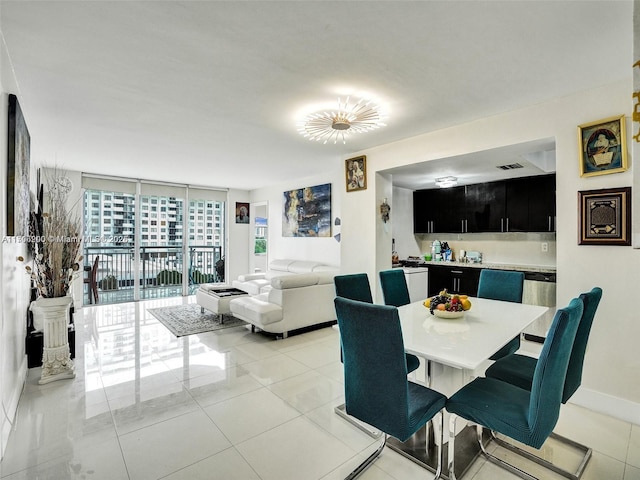 tiled dining space featuring expansive windows