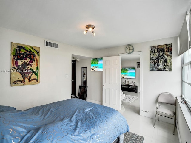 bedroom with light tile patterned floors