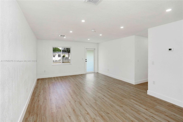 spare room featuring light hardwood / wood-style floors