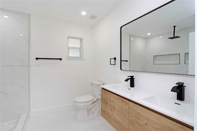 bathroom with toilet, vanity, and walk in shower