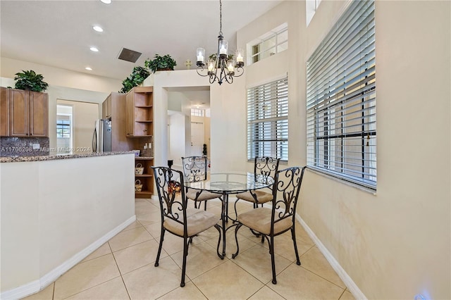 dining space featuring a chandelier and light tile patterned flooring