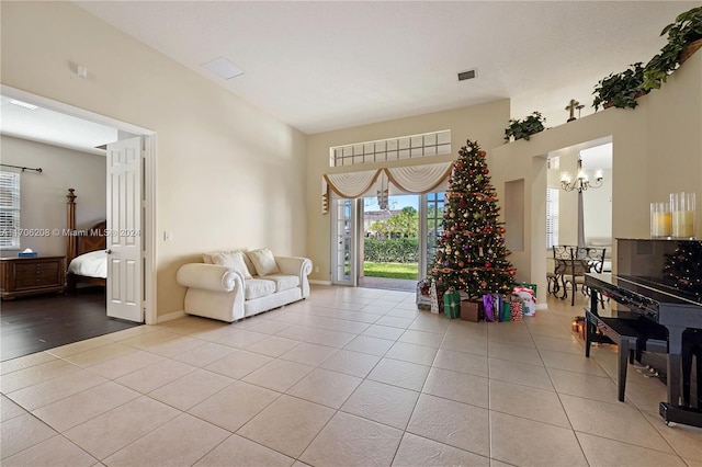 tiled living room featuring a notable chandelier