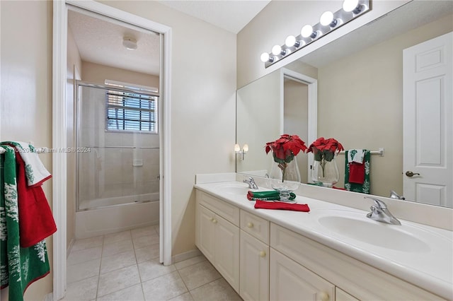 bathroom featuring tile patterned flooring, a textured ceiling, vanity, and shower / bath combination with glass door