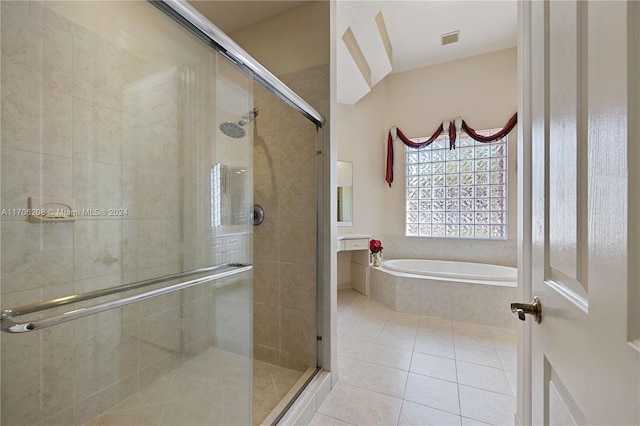 bathroom with tile patterned floors and shower with separate bathtub