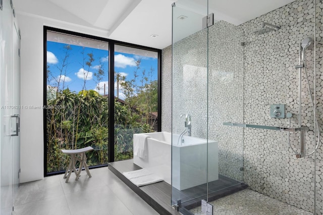 bathroom with floor to ceiling windows and independent shower and bath