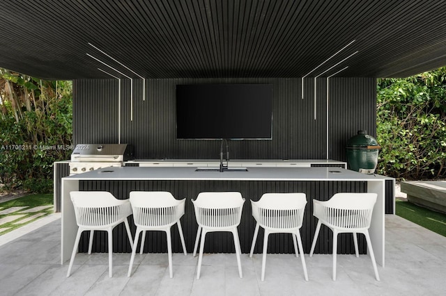 view of patio featuring a grill and an outdoor wet bar