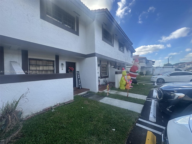 view of side of home with a yard