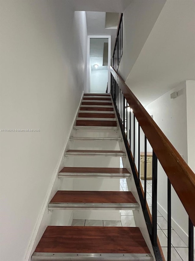 stairs featuring tile patterned flooring