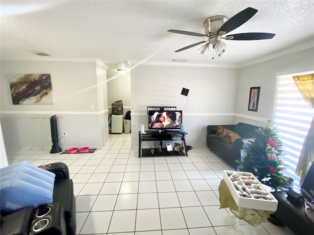 tiled living room featuring crown molding, ceiling fan, and a textured ceiling