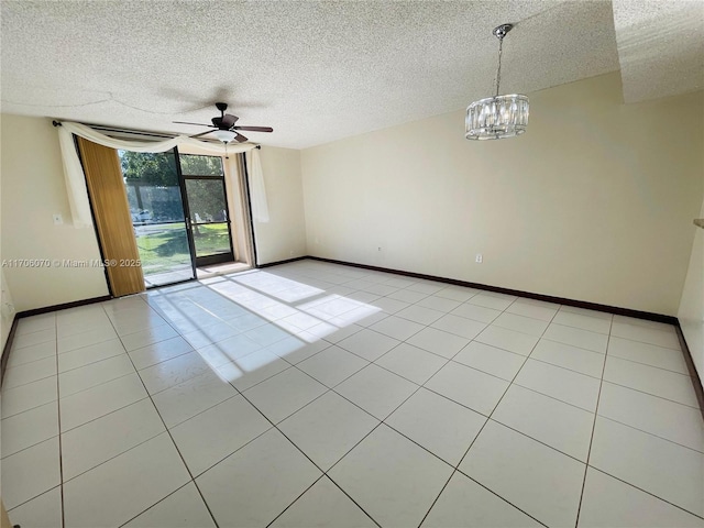 tiled empty room with ceiling fan with notable chandelier and a textured ceiling