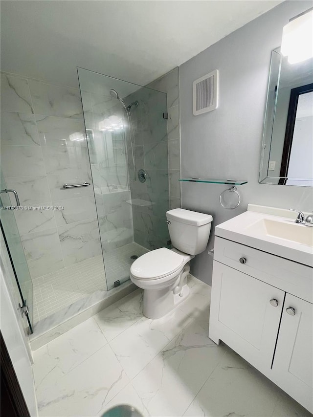 bathroom with vanity, toilet, and a shower with door