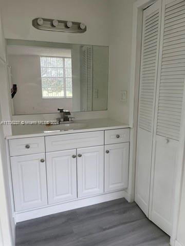 bathroom featuring vanity and hardwood / wood-style flooring